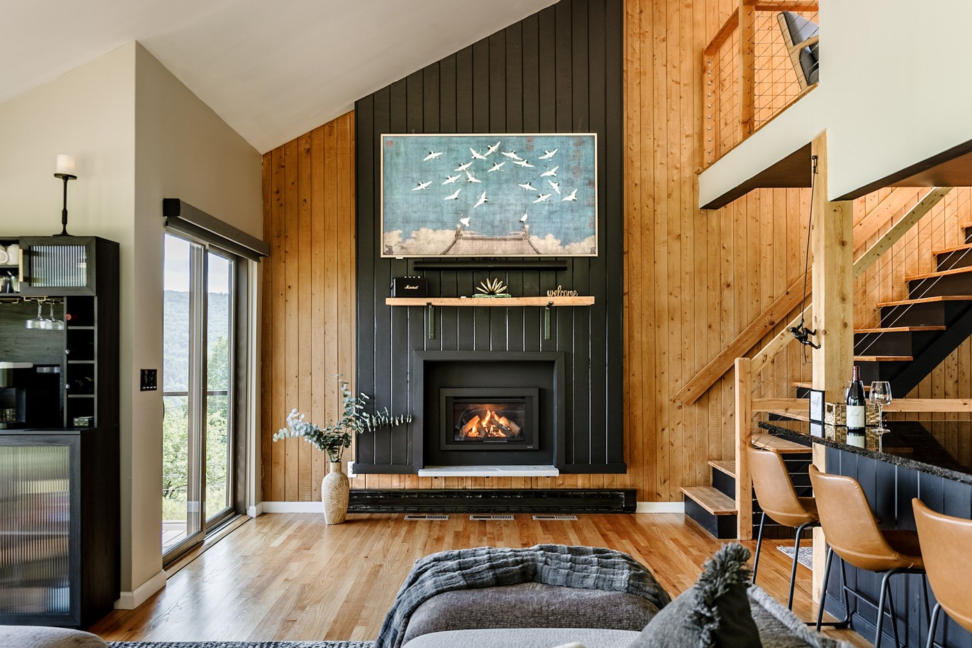 Living room with gas fireplace and floor-to-ceiling mountain views